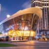Illuminated Dubai Opera building at night in Downtown Dubai, showcasing modern architecture on exclusive private city tours.
