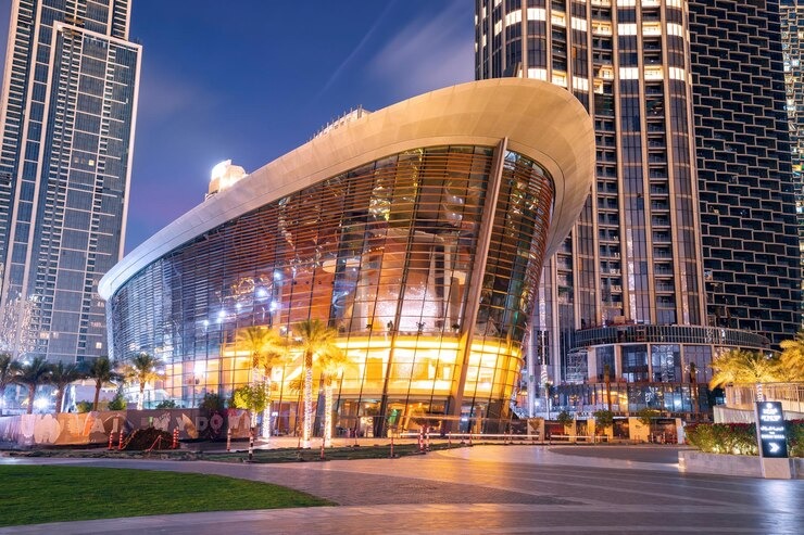 Illuminated Dubai Opera building at night in Downtown Dubai, showcasing modern architecture on exclusive private city tours.