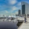 Private Yacht Rental Dubai at a modern marina with luxury yachts docked beside Dubai’s waterfront skyline.